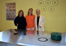 Mirjam de Bruijn, Merel Philippart (founder) and Bernadette de Leeuw (from left to right) at the stand of Makus, which presented the MAKUS Moon at Design District: the world's first induction cooktop with extraction and color.
