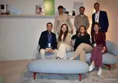 The team of Artifort\Lande on the luxurious, sculptural Muse sofa (with a curved, arch-shaped back), from left to right in the back row Kees Tol, Ron Davies, and Vincent van den Broek and sitting Maurits van der Lande, Anouk Jager, Barbara van Poucke, and Annemijn Evers.