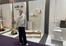 Joan Bebronne designer at Mademoiselle Jo is standing next to the new salon table with customisable leather cord.