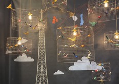 The renowned "La Petite Volière" lamps by Mathieu Challières Paris are delicate, artistic lighting fixtures featuring intricate birdcage designs adorned with lifelike, hand-colored birds.